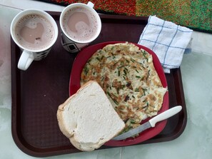 A tray with two cups of coffee, a slice of bread, and a plate with a vegetable omelette. - TOSH, Sitting Room with Bedroom Ensuite (Ako-Adjei, Accra)