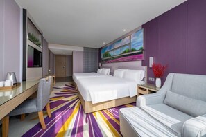 A modern hotel room with a large bed, a sofa, a desk, and a TV. - Lavande Hotels (Zhuhai Tangjia University Town) (Zhuhai)