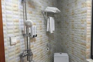 A bathroom with a shower, toilet, and towel rack. - Meiguiyuan Business Hotel (Yongchun)