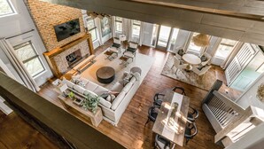 A spacious living area with a fireplace, seating, and a dining area.