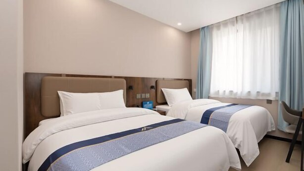 A hotel room with two beds, a nightstand, a chair, and a window with curtains. - Aifeel Hotel (Beijing Lishuiqiao Subway Station) (Beijing)