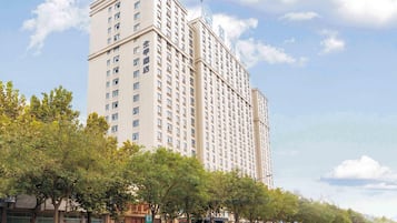 A high-rise hotel with multiple floors, a prominent entrance, and a clear view of the surrounding urban environment.