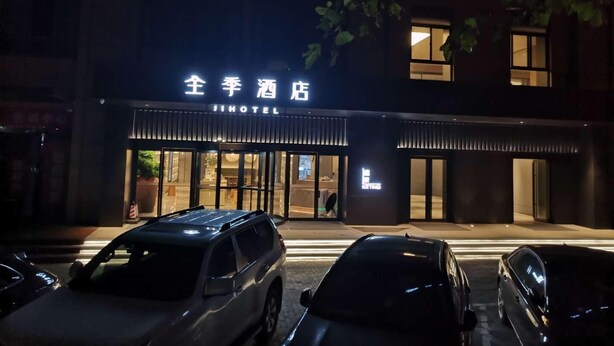 A hotel entrance with a sign reading "JI HOTEL" and a visible entrance door. - Ji Hotel (Kaifeng)