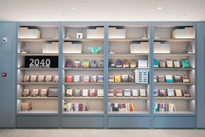 A bookshelf with books and a sign that reads '2040 BOOKSTORE.' - Ji Hotel (future Road Store, Convention & Exhibiti (Zhengzhou)