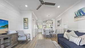 A modern living room with a sofa, chairs, a dining area, and a kitchen in the background. - Villa 5087 on Duck Key Boat Slip Available - 2BD 2.5BA (Duck Key)