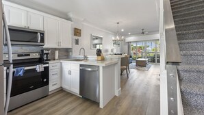 A modern kitchen with white cabinetry, stainless steel appliances, and a central island. - Villa 5087 on Duck Key Boat Slip Available - 2BD 2.5BA (Duck Key)