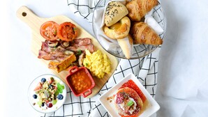 A breakfast spread with croissants, eggs, tomatoes, and a dessert. - Chengdu Taihe International Hotel (Chengdu)
