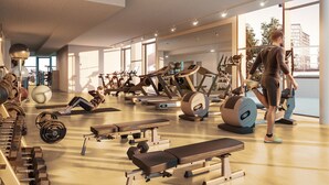 Ein modernes Fitnessstudio mit verschiedenen Trainingsgeräten, großen Fenstern und Blick auf die Stadt.