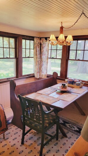 Dine and enjoy the panoramic view of the yard and trees.