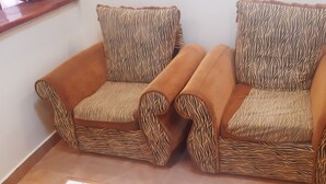 Two armchairs with zebra-patterned upholstery and wooden armrests. - Lena Cottage - 10km from Nanyuki Town towards Timau (Nanyuki)