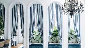 A room with a pool, striped curtains, a chandelier, and a blue sofa. - OriVista Stylish 3BR Villa Muzo in Seminyak, Pool, Wifi, Beach (Seminyak)