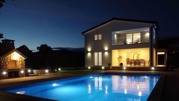 A modern two-story house with a swimming pool at dusk. - Villa Maria by Interhome (Imotski)