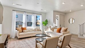 A modern living room with two sofas, a coffee table, and a potted plant. - Mavericks Retreat by RedAwning (St. George)
