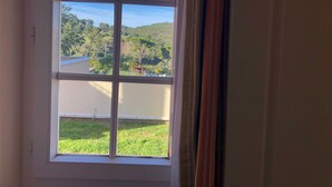 A window with a view of a grassy area and trees. - Cap Esterel Agay - large garden - exceptional sea and pool views (Saint-Raphaël)