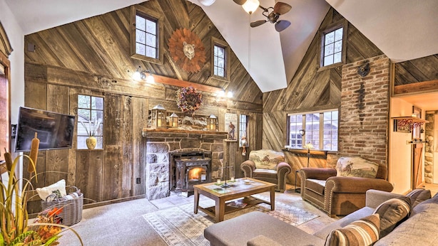 A rustic interior with a stone fireplace, wooden walls, and a cozy seating area. - Walk to Zigzag River: ‘The Sundance’ Cottage (Rhododendron)
