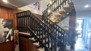 A staircase with wooden steps and black railings, leading to an upper floor. - Location Location! T Two on Whakaue  (Rotorua)