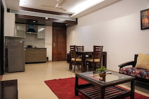 Suite | Living area | 42-inch flat-screen TV with cable channels - Yuhi Suites (Gurugram)