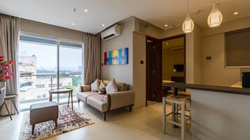 Suite Room with Balcony | Living area | 32-inch Smart TV with digital channels, TV
