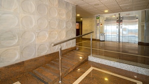 A clean, modern elevator area with stainless steel elevators, a handrail, and a patterned wall. - Holiday Apartment "WG1 Benidorm" Near the Beach with Sea View, Balcony, Air Conditioning and Wi-Fi (Benidorm)