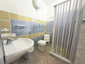 A bathroom with a sink, toilet, and shower.