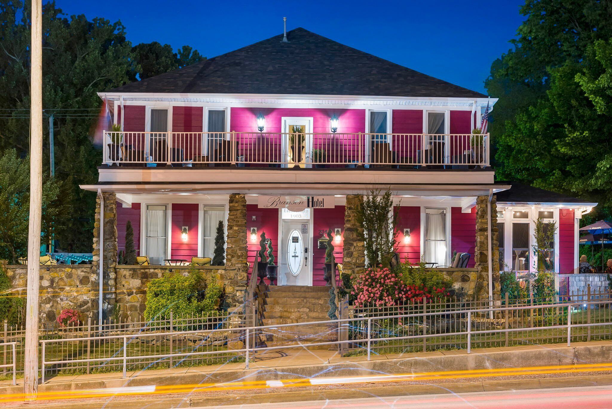 A two-story hotel with a balcony, stone facade, and a sign reading "Branson Hotel."