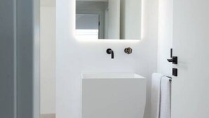 A modern bathroom with a white sink, a mirror, and a towel hanging on a rack. - Apartment Ogliarola - Maina Country Resort - with pool, in Sicily (Cresta)