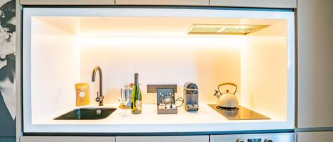 A modern kitchen with a built-in refrigerator, a sink, and a stove.