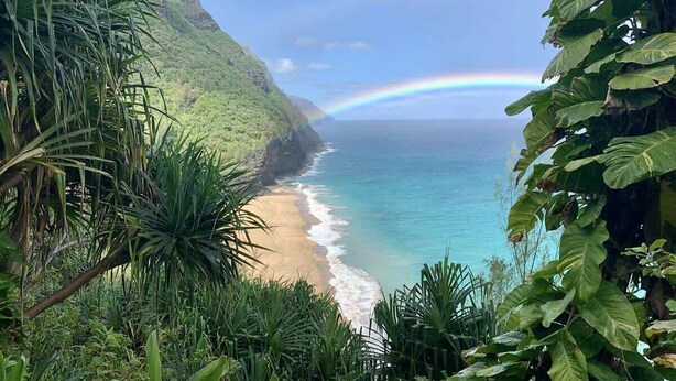 A coastal landscape with a beach, ocean, and a mountain. - Unbeatable Ocean Front Condo  Pono Kai Resort C302 (Kapa'a)