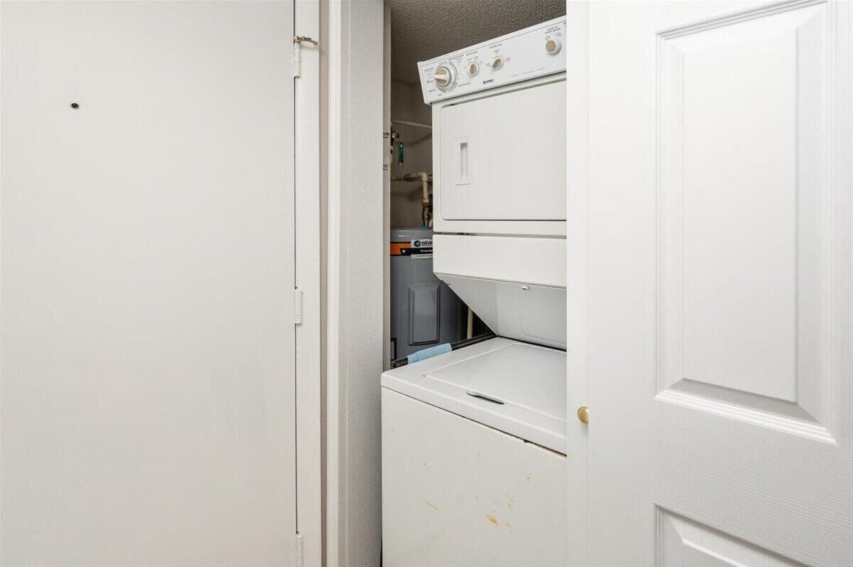 A laundry room with stacked washers and dryers.