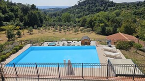 A rectangular swimming pool with a surrounding fence, a covered seating area, and a view of a hilly landscape. - Casa Francia, Palaia, Pisa and Valdera (Palaia)