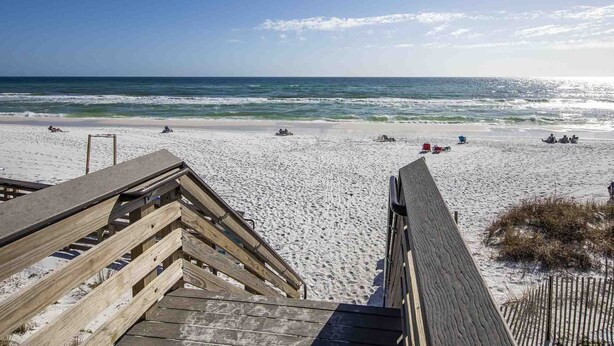 A beach with wooden boardwalks leading to the shore, sandy beach, and ocean waves. - View from the Top  -  4 Bikes, Golf Cart, Views! (Santa Rosa Beach)