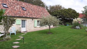A stone house with a tiled roof, a small garden with a lawn, a white door, and green shutters. - "La Beuvrequentoise 2" just a stone's throw from Boulogne sur mer with NAUSICCA, Wissant  (Beuvrequen)