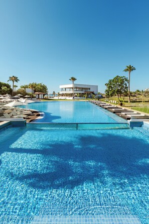 Seasonal outdoor pool, open 9:00 AM to 7:00 PM, pool umbrellas