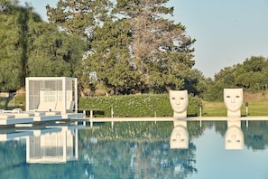 Seasonal outdoor pool, open 9:00 AM to 7:00 PM, pool umbrellas