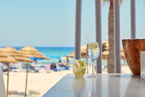 On the beach, white sand, sun-loungers, beach umbrellas