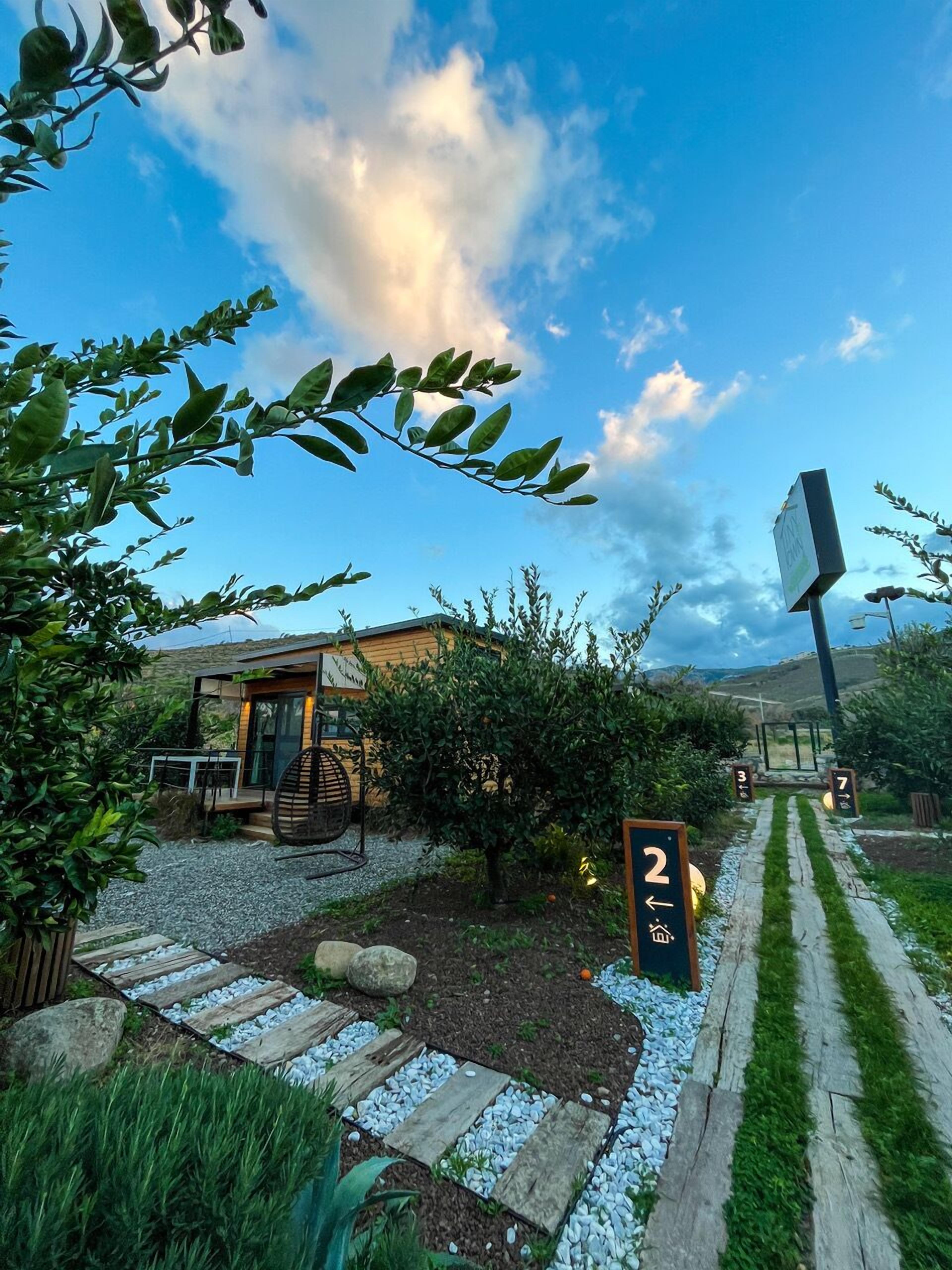 A pathway leading to a building with a sign indicating room number 2.