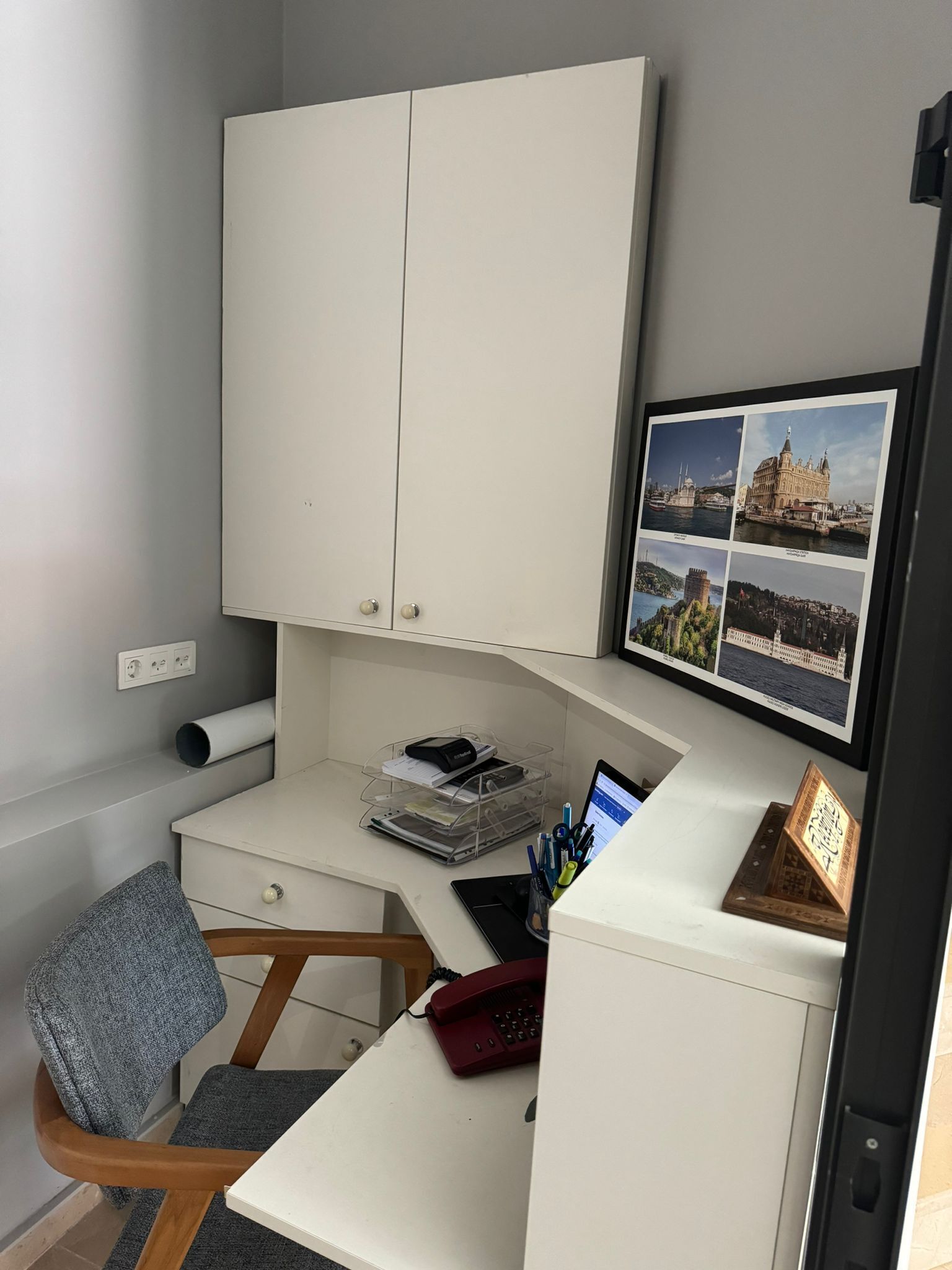 A workspace with a desk, chair, and a cabinet.
