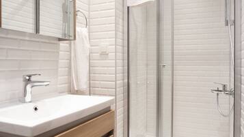 Shower, hair dryer, slippers, towels