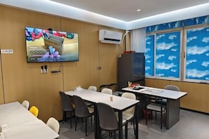 A hotel room with a television, air conditioning unit, and a large window with a view. - YuanRui Hotel ( Financial City Keyun Road Subway Station Store) (Guangzhou)
