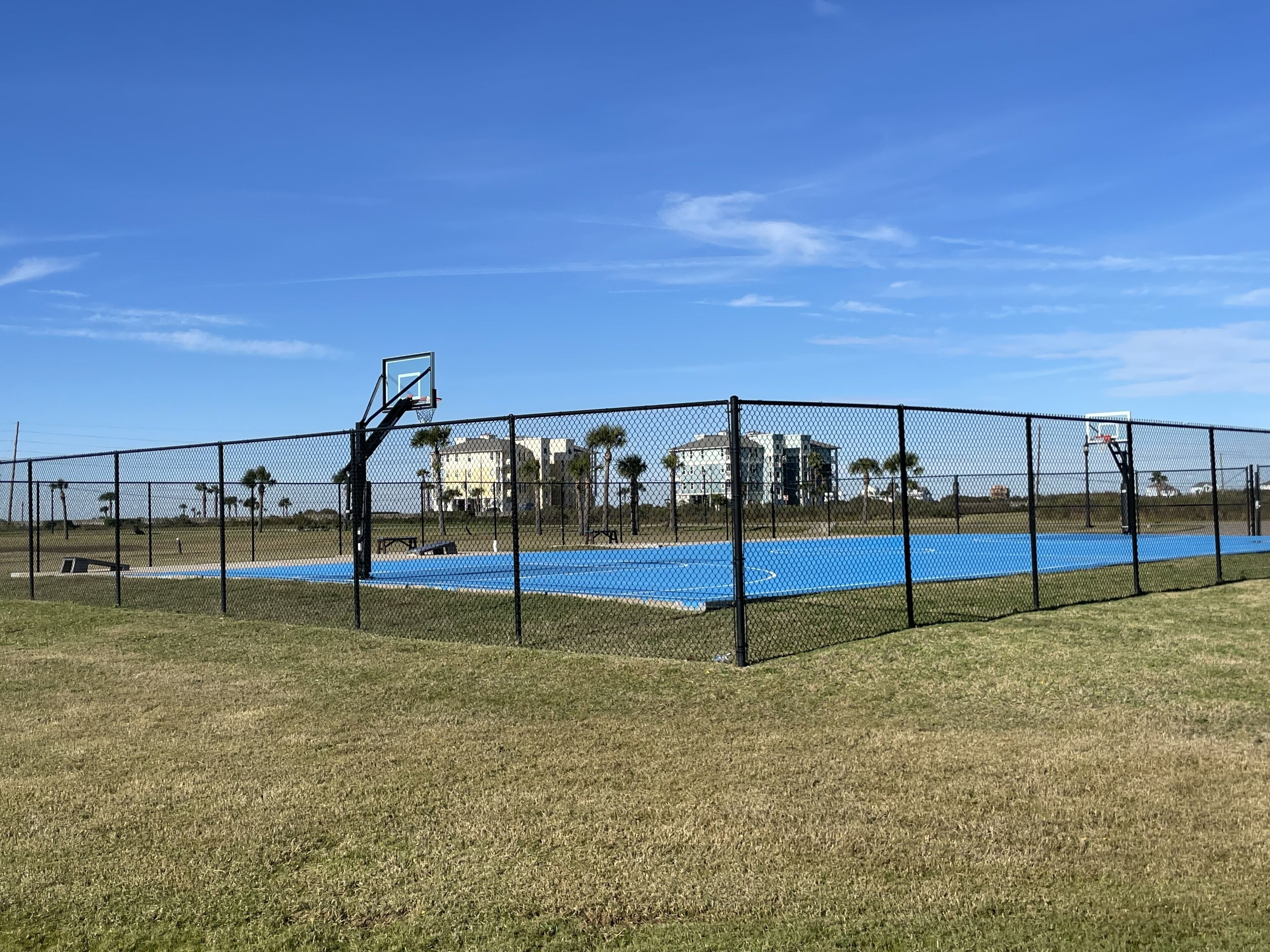 Full size basketball court with corn hole for loads of family fun.