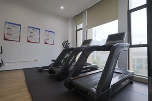 A gym with treadmills, exercise mats, and large windows. - Haizhongzhou International Hotel Apartment Building (Zhoushan)