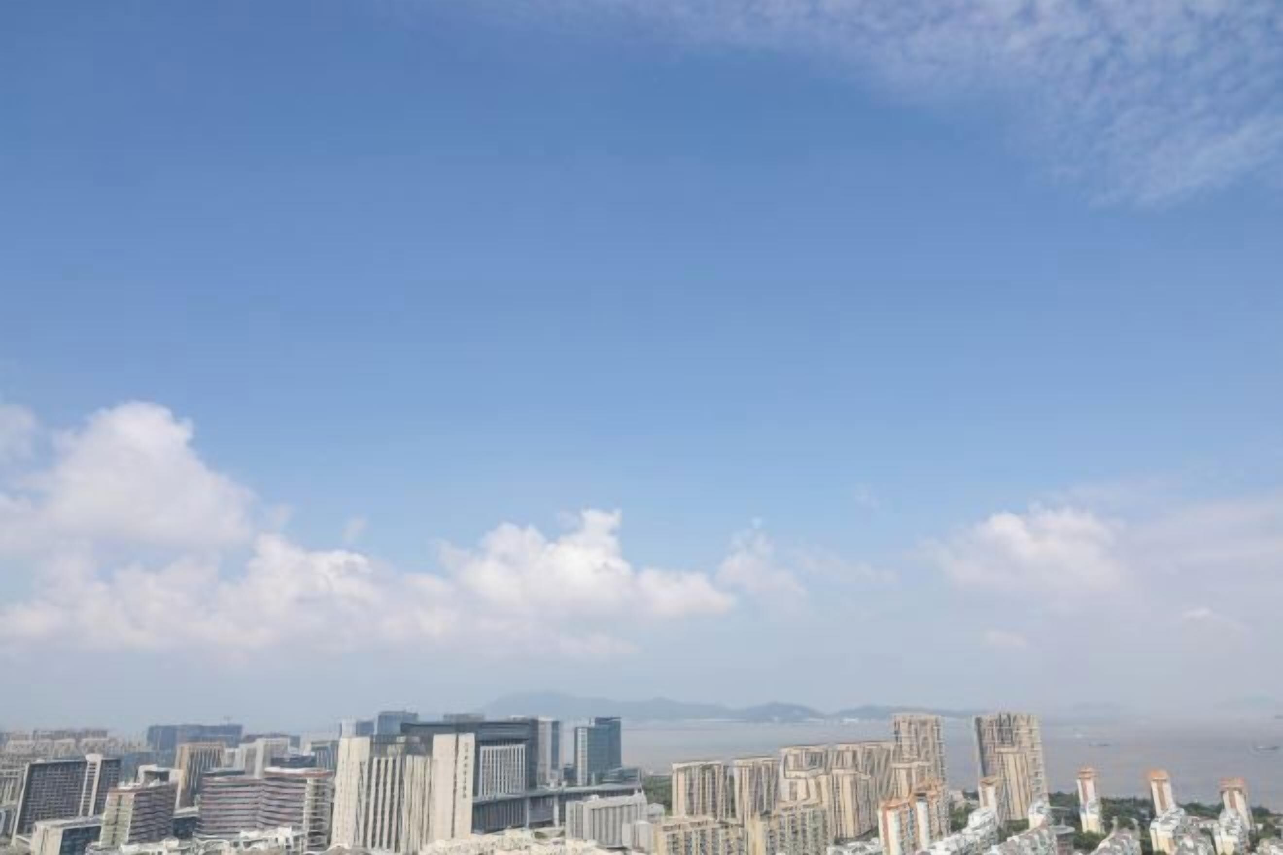 A cityscape with high-rise buildings and a clear sky.