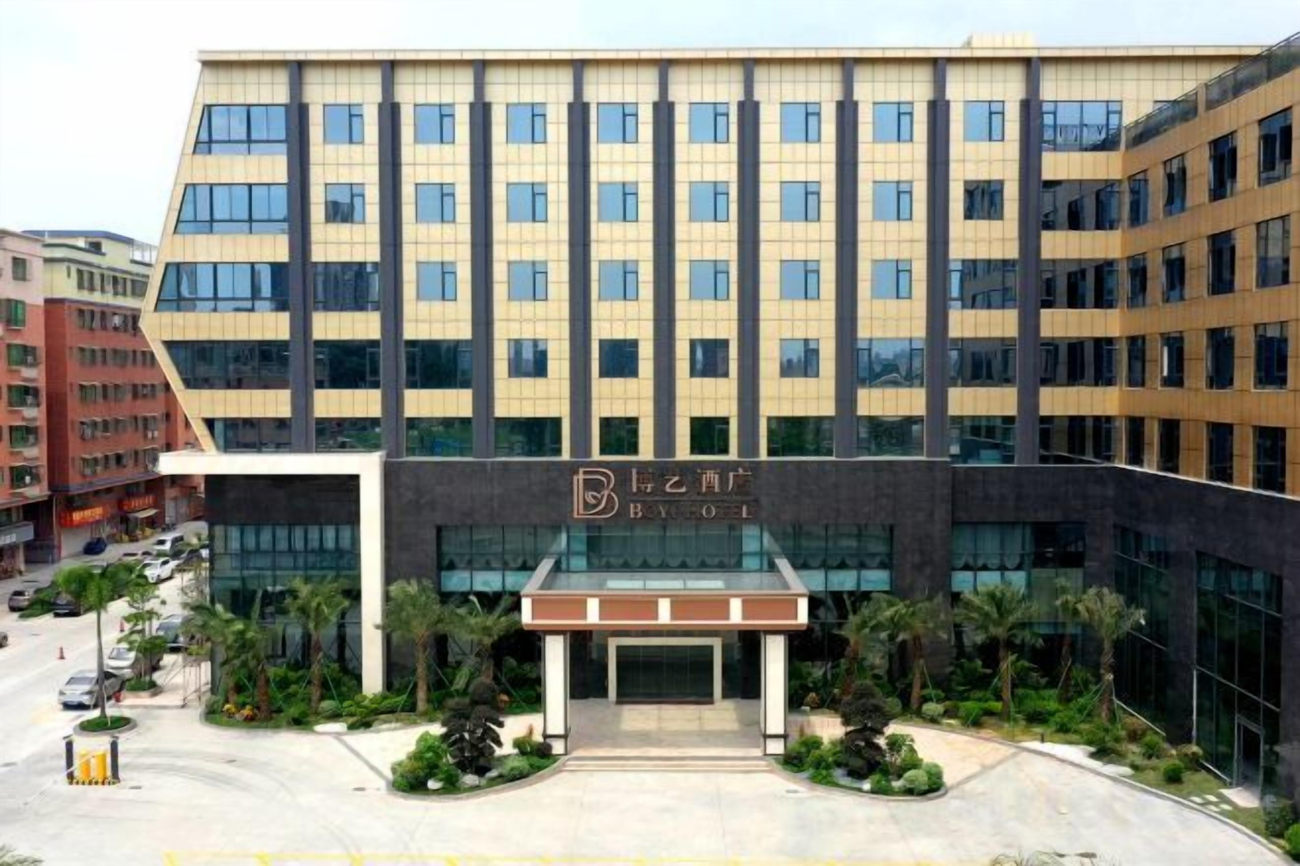 A modern hotel building with a glass entrance and a sign that reads 'B to C Hotel.'