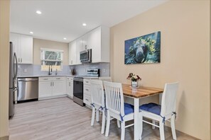 Enjoy meals in the kitchen with a refrigerator, microwave, and dishwasher. Dine at the wooden table with comfortable chairs.