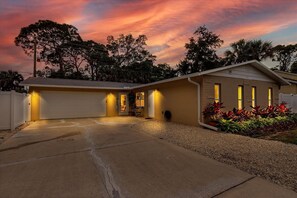 Stunning home with a well-manicured front yard and a driveway.