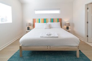 Cozy retreat with a single bed, two bedside tables, and a large window.