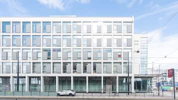 Stunning building with a symmetrical facade, featuring a grid of windows and a glass entrance.