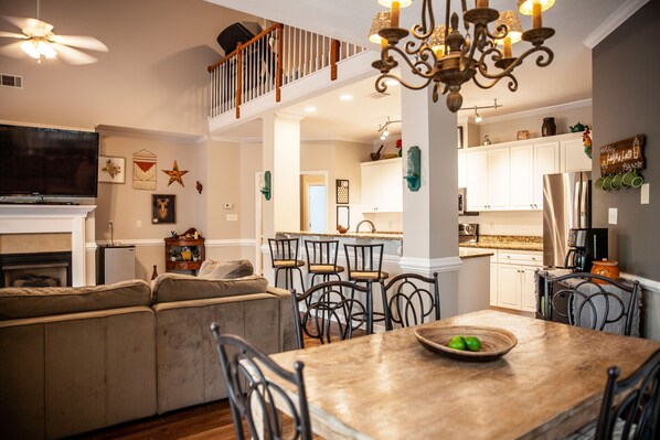 Relax in this well-appointed living area with a high ceiling, comfortable sofa, and dining table for six.