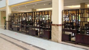 A spacious indoor area with multiple seating arrangements and a decorative partition. - Tongfa Hot Spring Hotel (Wanning)