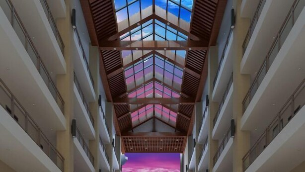 A modern atrium with a geometric ceiling design and a view of a pink and purple sky through the windows. - Tongfa Hot Spring Hotel (Wanning)